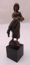 A late 19th century bronze figurine of a girl holding a sheaf of wheat, indistinctly signed to the