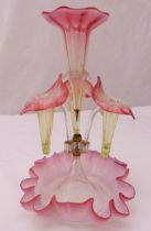 An early 20th century glass epergne with detachable glass floral vases on shaped circular glass