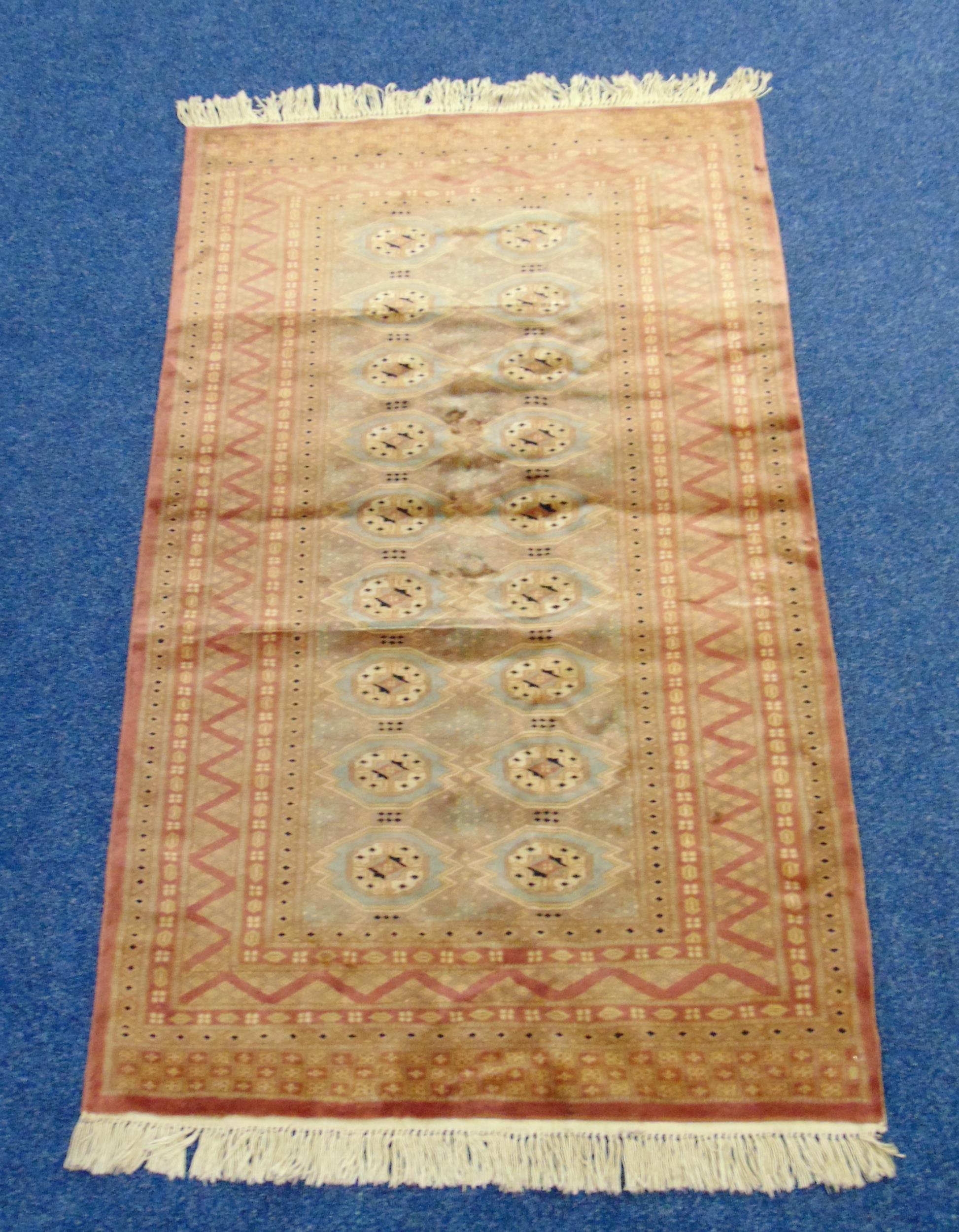 An Afghan silk and wool carpet with repeating geometric patterns and border, 170 x 94cm