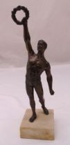 A 19th century spelter figurine of a Grecian athlete holding a wreath mounted on a white onyx square