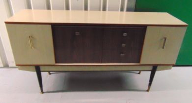 A mid 20th century rectangular veneered sideboard with cupboards and drawers on four tapering