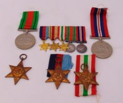 A quantity of WWII military medals and ribbons to include 1939–1945 Star, The Italy Star, The Africa