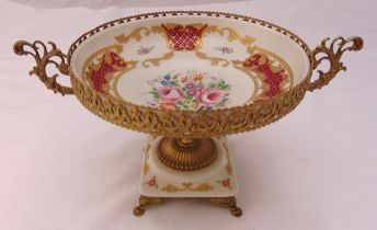 A continental ceramic and gilded metal table centrepiece of circular form decorated with flowers and