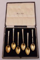 A cased set of hallmarked silver gilt coffee spoons with enamel terminals, Birmingham 1956
