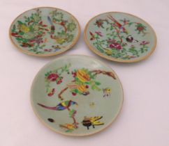 Three oriental celadon plates decorated with birds, flowers and leaves, character marks to the