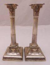 A pair of hallmarked silver Corinthian column table candlesticks, fluted columns on raised square