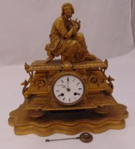 A late 19th century French spelter mantle clock, circular white enamel dial with Roman numerals