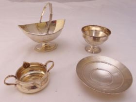 A quantity of hallmarked silver to include a sugar bowl with swing handle, two bonbon dishes and a