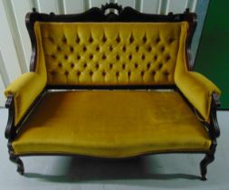 A Victorian upholstered two seater settle on four scroll legs