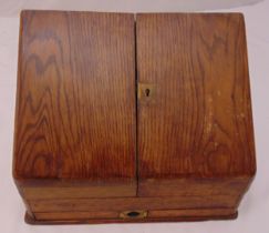 Victorian oak rectangular stationery cabinet with two hinged doors revealing fitted interior and a