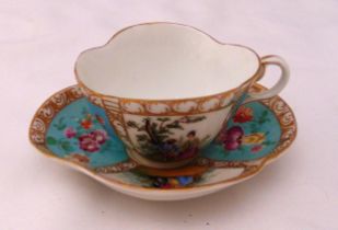 A continental cabinet cup and saucer decorated with figures, flowers and leaves