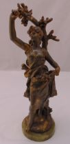 A 20th century spelter figurine of a lady beneath a tree on raised circular marble base, foundry