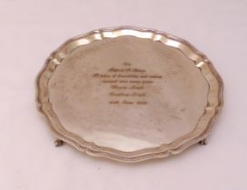 A hallmarked silver presentation salver on four ball and claw feet, Birmingham 1970 by Garrard and