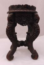 A 19th century oriental carved hardwood plant stand the four scrolling legs with elephant mounts, 45