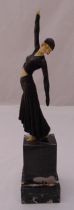 An Art Deco early 20th century bronzed figurine of a lady striking a pose on raised rectangular