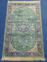 Sarook Kashan silk carpet, green ground with repeating floral design and blue border with