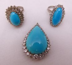 Two white metal turquoise and diamond rings and a matching pendant