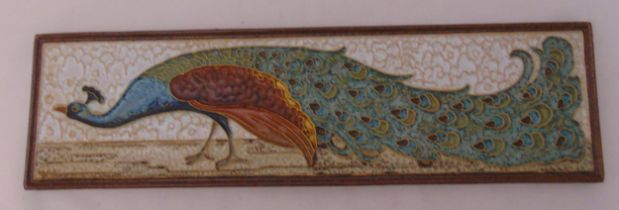 An Art Nouveau Delft rectangular wall plaque of a peacock, marks to the verso, 43cm (w)