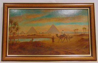 A framed oil on panel of figures and camels by a watering hole, monogrammed bottom left, 34.5 x 59.