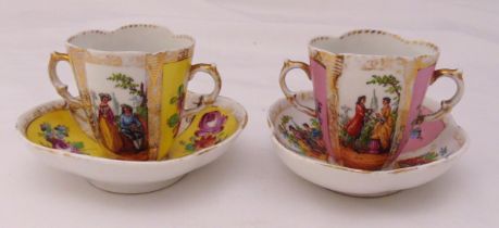 Two Augustus Rex chocolate cups and saucers with double scroll handles the sides decorated with