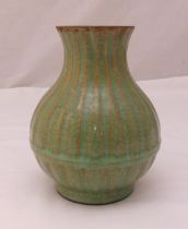 A Chinese Song style celadon baluster vase with vertically ribbed decoration and a central band,