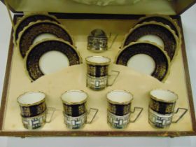 Aynsley cased coffee set to include cups, saucers and hallmarked silver cup holders