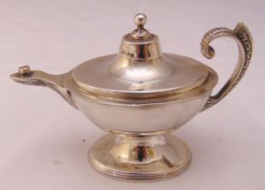 A Victorian hallmarked silver cigar lighter in the form of Aladdin's lamp with flying scroll handle,