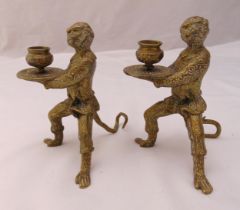 A pair of Indian brass candlesticks in the form of monkeys, 17cm (h)