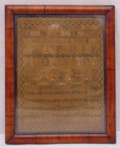 A framed and glazed needlework sampler dated 1821 of customary form, 52 x 42cm