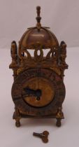 Smiths brass lantern clock of 17th century form with Roman numerals on four baluster supports to