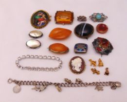 A quantity of costume jewellery to include brooches, bracelets and charms