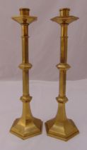 A pair of Victorian brass candlesticks of rectangular form on raised square bases and a brass
