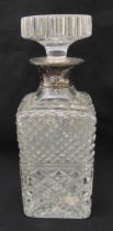 A cut glass decanter tapering rectangular form with drop stopper and silver collar