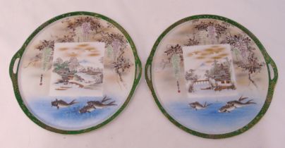 A pair of oriental plates decorated with fish, flowers and leaves, 29cm (dia)