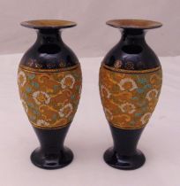 A pair of Royal Doulton baluster vases decorated with flowers and gilding, marks to the bases, 23.