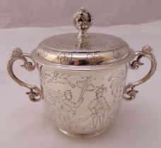 A hallmarked silver two handled porringer in early 18th century Chinoserie style, the raised pull
