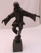 H. Milani bronzed figurine of Pagliacci balancing on a ball on rectangular plinth, signed to the