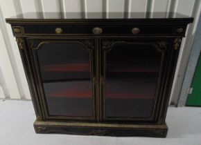 A Victorian ebonised rectangular glazed display cabinet with two hinged doors and applied