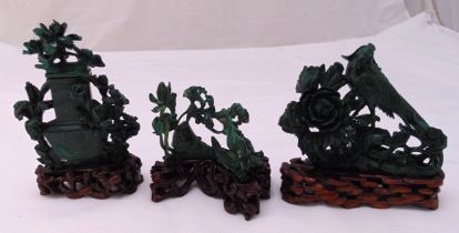 Three Chinese carved malachite figurines to include hardwood stands