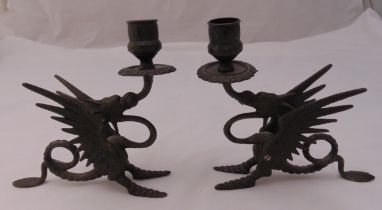 A pair of bronze candlesticks in the form of stylised dragons, 18cm (h)