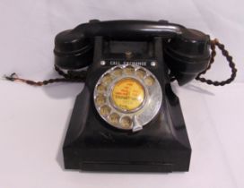 A mid 20th century Bakelite telephone of customary form with original cord