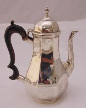 A hallmarked silver coffee pot of panelled pear shape with double scroll wooden handle, domed hinged