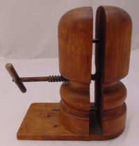 A vintage wooden millinery hat block stretcher on a rectangular base, 33.5cm (h)