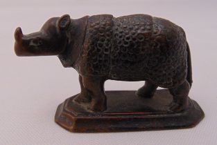 A 19th century bronze miniature model of a rhinoceros on raised octagonal base, 6.5cm (w)