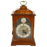 An electric or battery operated walnut-cased mantel clock, H30cm