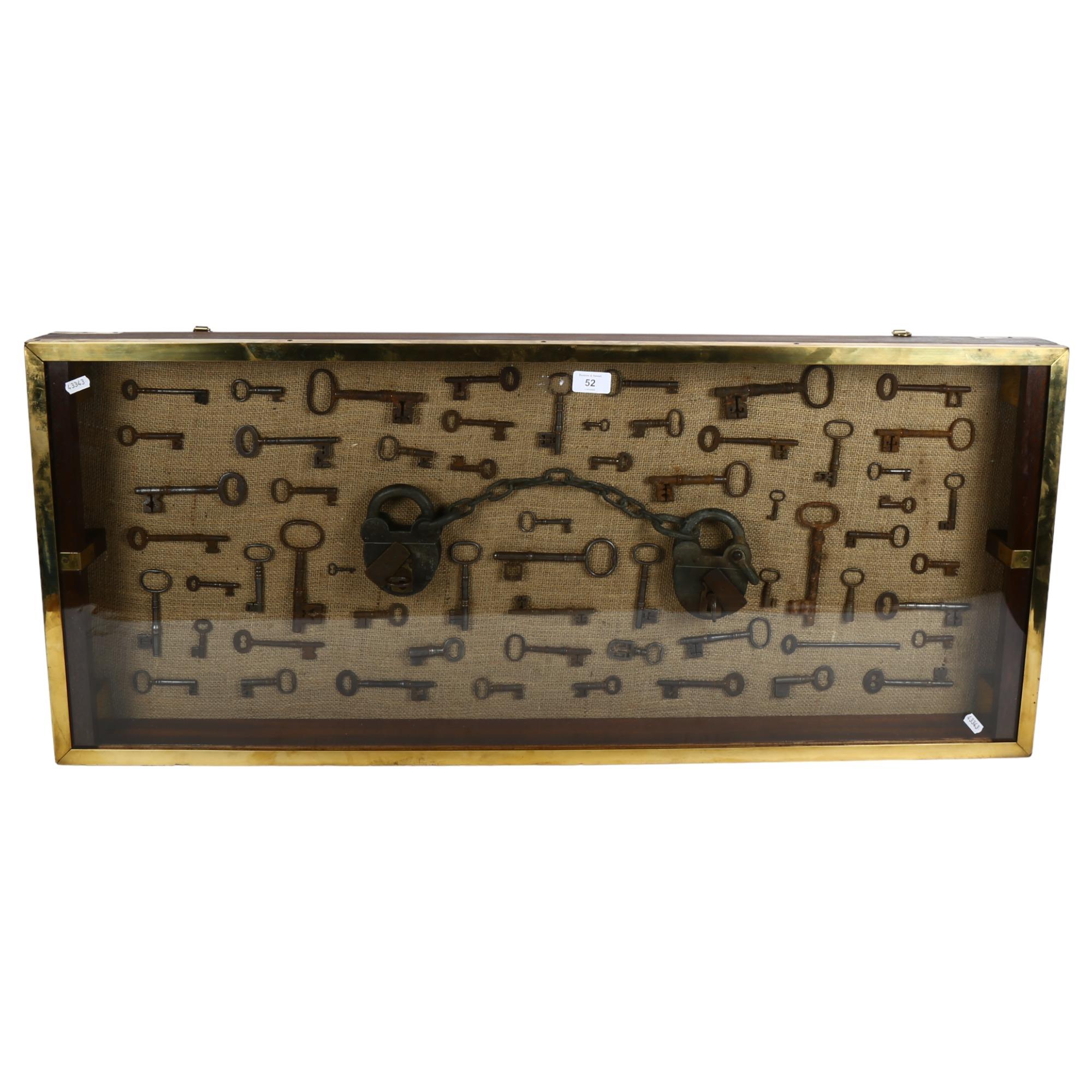 A large wall-hanging display case containing Vintage and Antique skeleton keys, including a set of