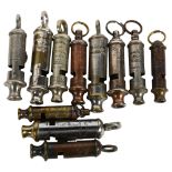 A quantity of Vintage police and boy scout whistles, including The Metropolitan Police whistle by