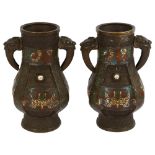 A pair of Chinese bronze and enamel archaic style vases, with mythical beast handles and enamelled