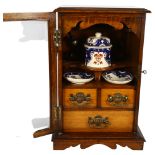 A Victorian oak smoker's cabinet, with mixing bowl and various accessories, H43cm