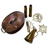 A Victorian copper fish kettle, 2 brass shell casings marked 1944, a brass pot stand with lion
